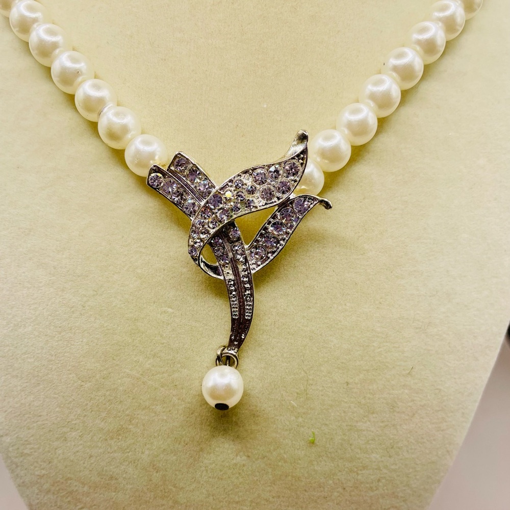 Faux pearl necklace with rhinestone pendant and a pearl tassel. 20 inches long.